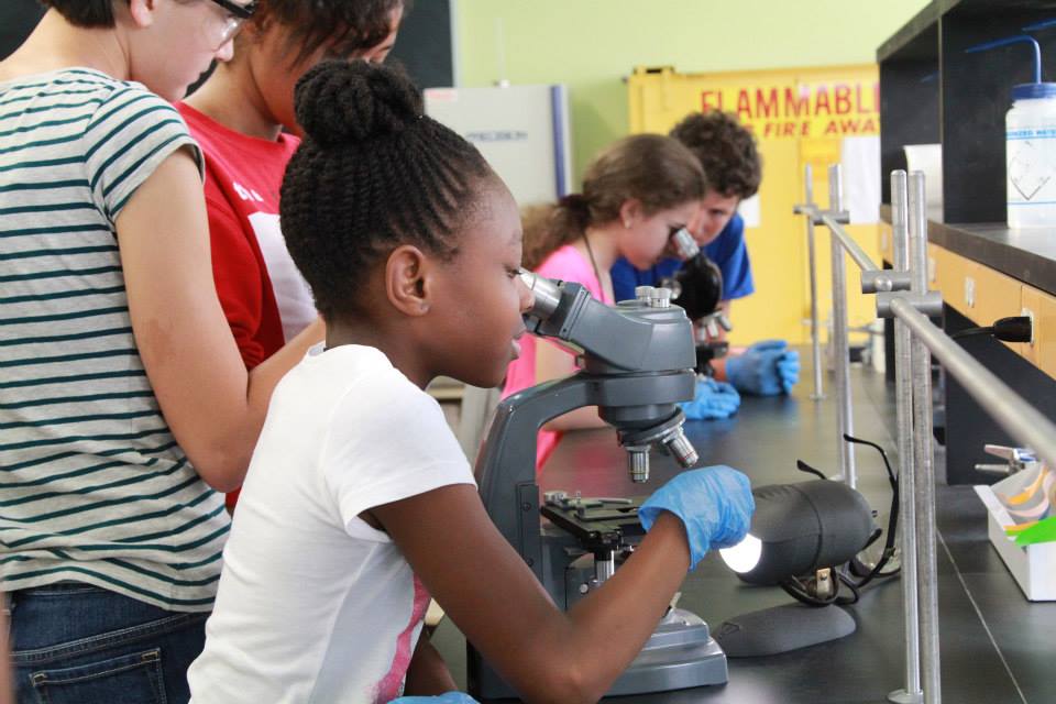 Veterinary medicine camp student with microsope cute.